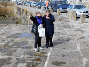 Marty and Ann look out to sea on the pier at  Porthleven. 