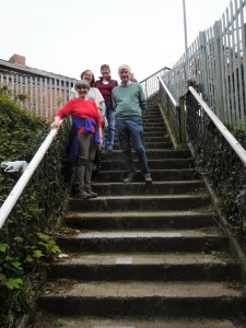 Marty, Jan, Lynne and Noel stand on the steps of the footbridge across the train tracks at Truro Station, the start of a walk outside the city. 